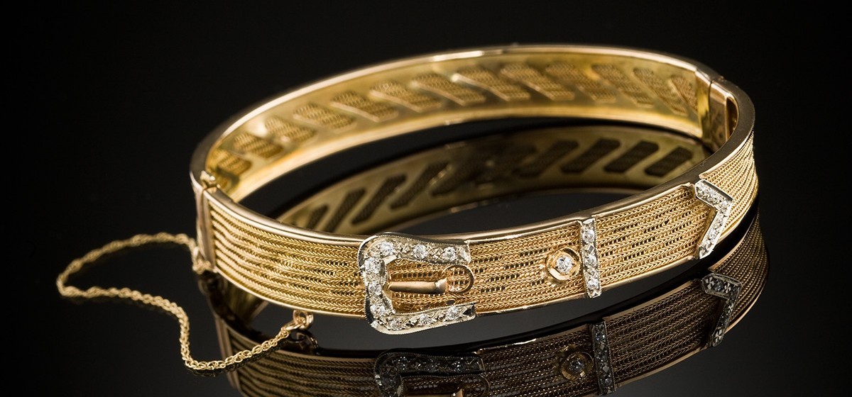 An antique diamond and yellow gold hinged buckle design bangle