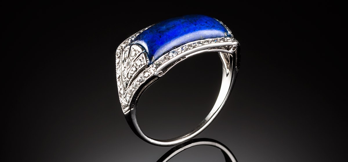 A French Art Deco lapis lazuli and diamond saddle style ring
