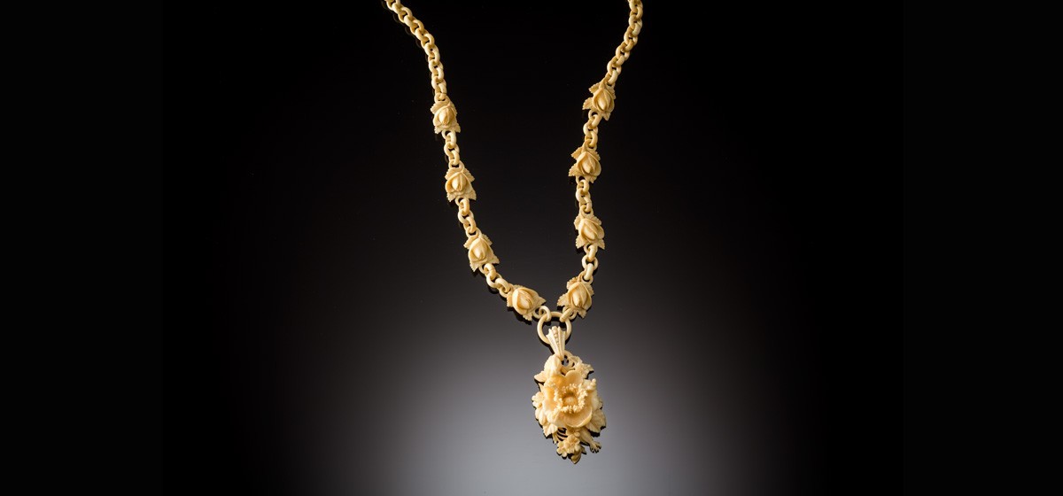 An Antique elaborately carved bone necklace and pendant