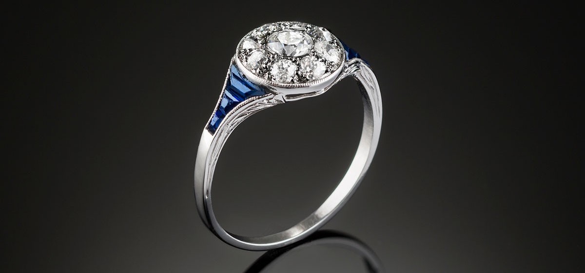 A classic art deco diamond sapphire and platinum round cluster ring 
