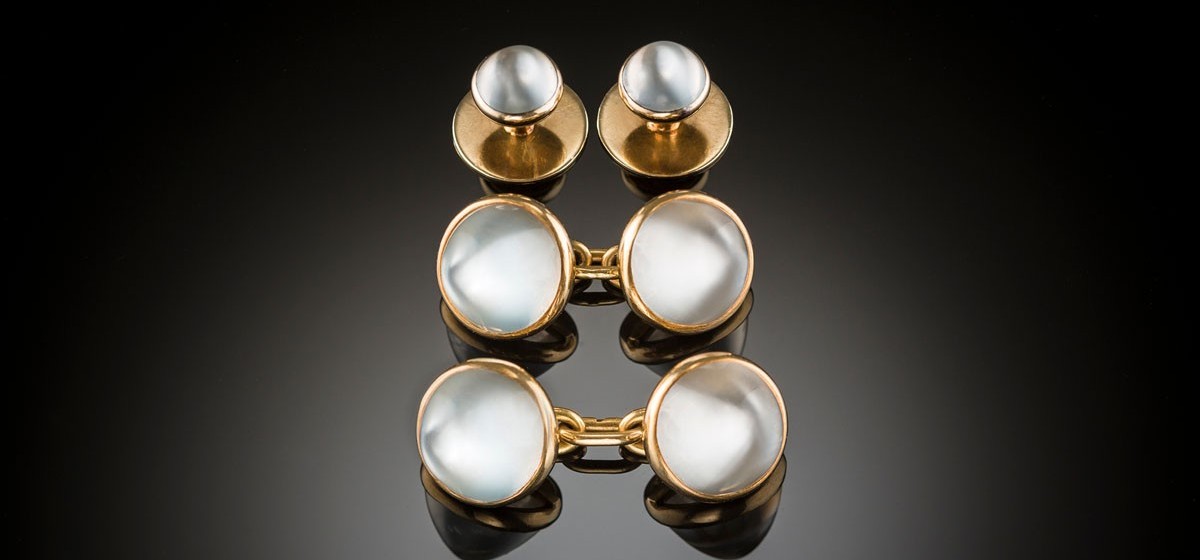 An early twentieth century pair of French double moonstone and gold sugarloaf cabochon cufflinks with matching collar buttons