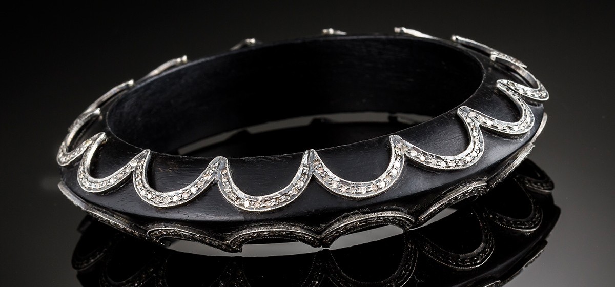 An Art Deco ebony and diamond set bangle