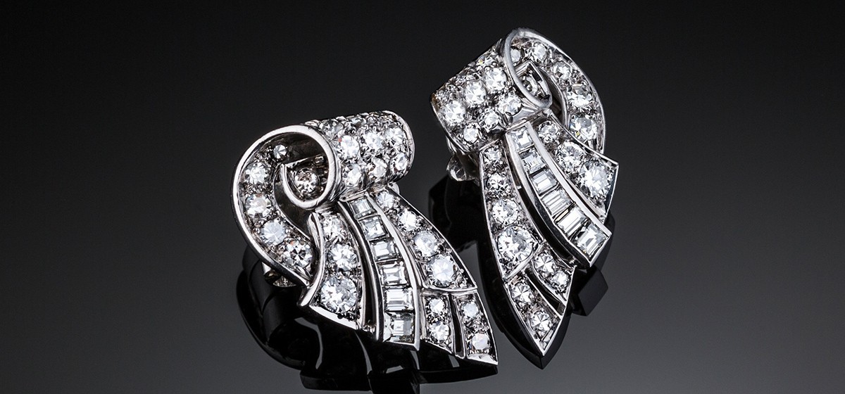 French Art Deco diamond set platinum ear clips in a scrolled wing design