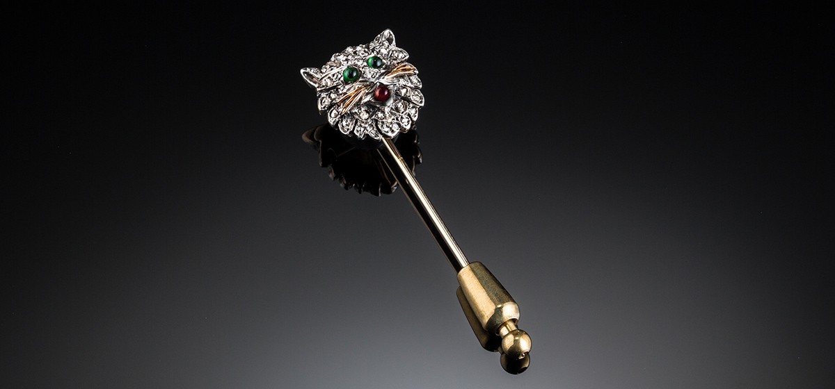 An Antique diamond cat’s head stick pin set in silver topped gold