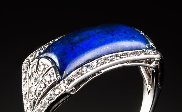 A French Art Deco lapis lazuli and diamond saddle style ring