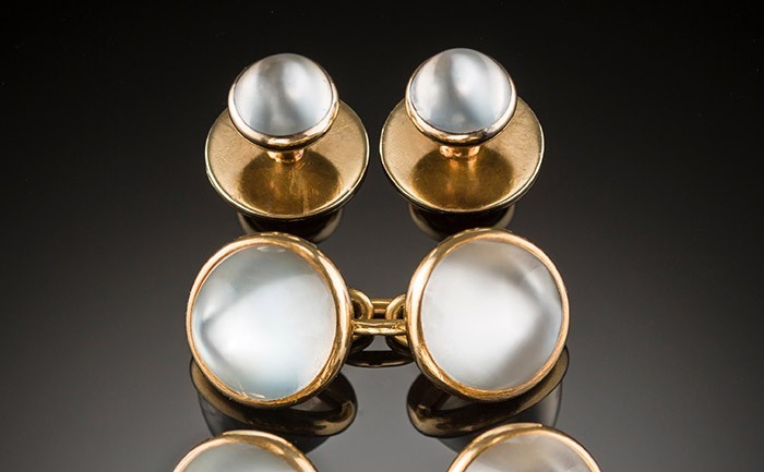 An early twentieth century pair of French double moonstone and gold sugarloaf cabochon cufflinks with matching collar buttons