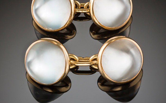 An early twentieth century pair of French double moonstone and gold sugarloaf cabochon cufflinks with matching collar buttons