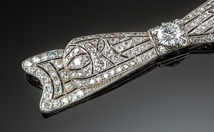 An Art Deco handcrafted platinum and diamond elongated bow brooch 