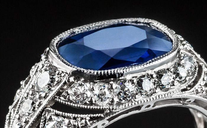 A PLATINUM ART DECO RING WITH A CUSHION SHAPE SAPPHIRE AND TRANSITION CUT DIAMONDS