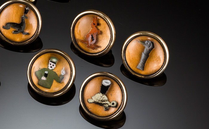 Detail of a 1920s set of reverse intaglio Essex crystal style Guinness cuff links and buttons / studs  depicting the zoo keeper and his animals