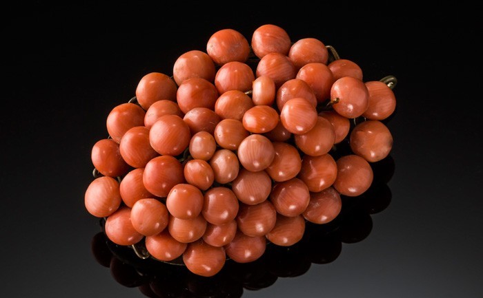 Detail of an Antique coral and gilt domed oval brooch/pendant