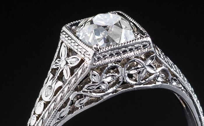 Detail of an Early Twentieth Century solitaire old cut diamond ring in an orange blossom platinum mount