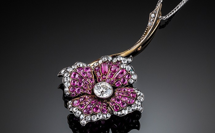 Detail of an Early Twentieth Century ruby and diamond flower pendant/brooch