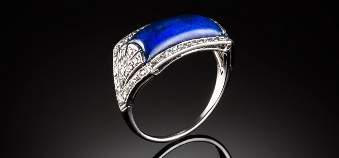 A French Art Deco lapis lazuli and diamond saddle style ring