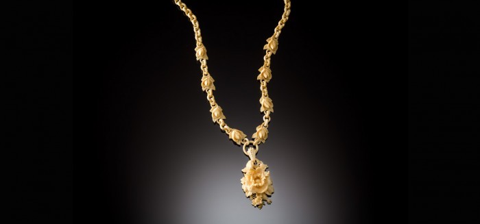 An Antique elaborately carved bone necklace and pendant