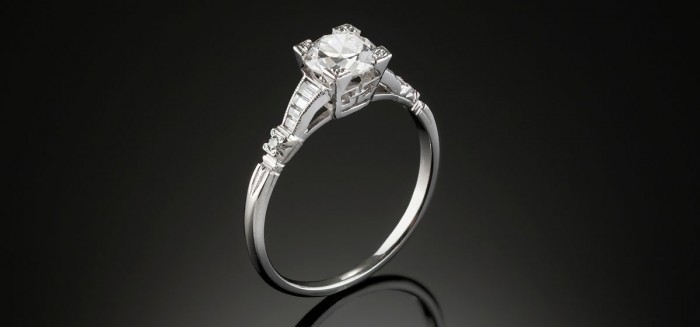 An Art Deco solitaire transition cut and graduated baguette cut diamond ring