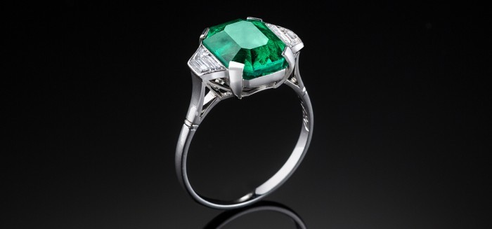 A French Art Deco large Columbian emerald and diamond platinum ring