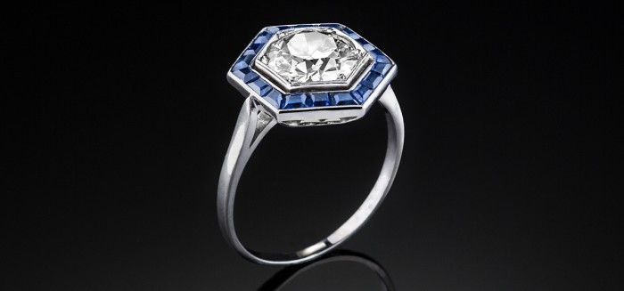 A French Art Deco platinum and diamond hexagonal ring with a sapphire border