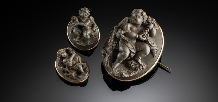 An Antique gold set lava cameo brooch from a demi parure with earrings