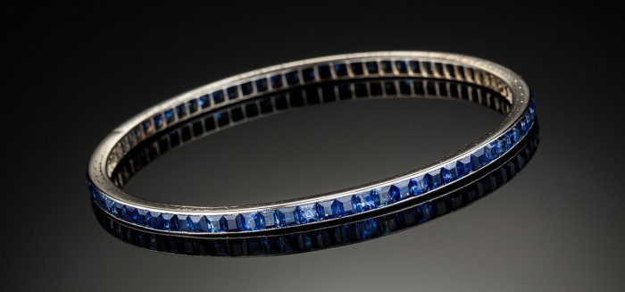 An Art Deco sapphire and white gold bangle with engraved edges