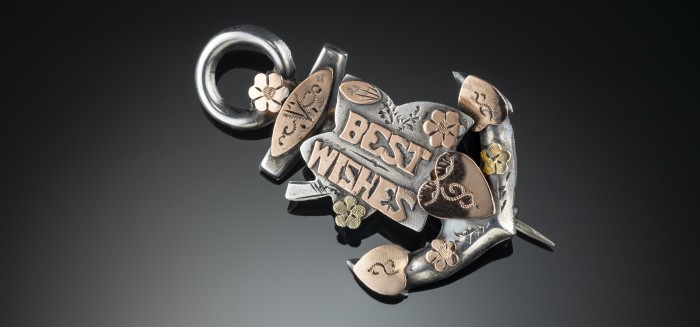 VICTORIAN SWEETHEART BROOCH/ PENDANT PROFUSELY DECORATED WITH GOLD HEARTS, FORGET ME NOTS AND “BEST WISHES” ON A SILVER ANCHOR