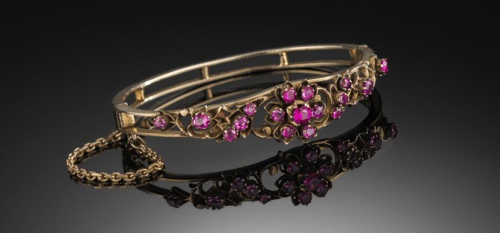 ANTIQUE SILVER GILT AND SYNTHETIC RUBIES HINGED BANGLE