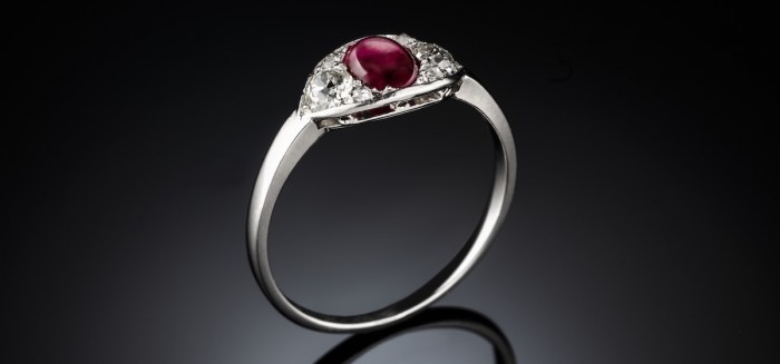 An art deco ruby and diamond set platinum and gold ring